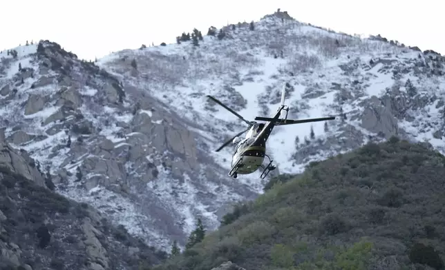 A Utah Department of Public Safety helicopter carries recovery crews from a staging area Friday, May 10, 2024, in Sandy, Utah. Two backcountry skiers were killed and one was rescued after an avalanche Thursday, in the mountains outside of Salt Lake City. (AP Photo/Rick Bowmer)