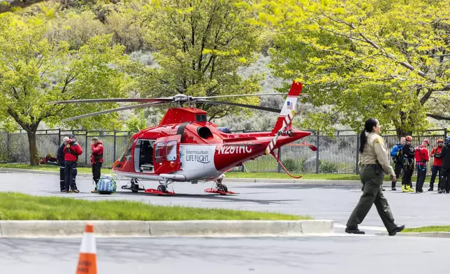 Emergency crews gather near Intermountain Life Flight at Hidden Valley Park in Sandy, Utah, after responding to a report of an avalanche and three missing skiers in Little Cottonwood Canyon on Thursday, May 9, 2024. (Isaac Hale/The Deseret News via AP)