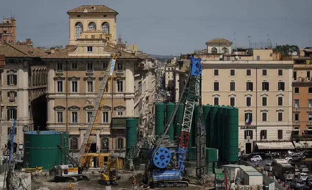 General view of the construction site of a major underground hub in central Piazza Venezia in Rome, Thursday, May 9, 2024. The Vatican crosses a key milestone Thursday in the runup to its 2025 Jubilee with the promulgation of the official decree establishing the Holy Year. For the next four years at least, central Piazza Venezia and its Imperial Forum-flanked boulevard to the Colosseum are scheduled to be congested and blighted by giant, 14-meter (yard) high green silos that are needed for the subway drilling operation under way. (AP Photo/Alessandra Tarantino)