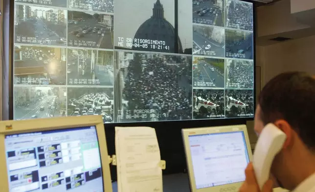 Live signals from the Vatican, St. Peter's Basilica, and the surrounding streets are seen in the control room at the municipal police headquarters in Rome, Wednesday, April 6, 2005. The Vatican crosses a key milestone Thursday, May 9, 2024, in the run-up to its 2025 Jubilee with the promulgation of the official decree establishing the Holy Year: a once-every-quarter-century event that is expected to bring some 32 million pilgrims to Rome and has already brought months of headaches to Romans. (AP Photo/Corrado Giambalvo)