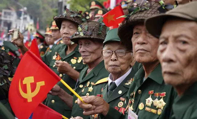 Veterans watch a parade commemorating the victory of Dien Bien Phu battle in Dien Bien Phu, Vietnam, Tuesday, May 7, 2024. Vietnam is celebrating the 70th anniversary of the battle of Dien Bien Phu, where the French army was defeated by Vietnamese troops, ending the French colonial rule in Vietnam. (AP Photo/Hau Dinh)