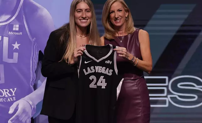 FILE - Iowa's Kate Martin, left, poses for a photo with WNBA commissioner Cathy Engelbert, right, after being selected 18th overall by the Las Vegas Aces during the second round of the WNBA basketball draft April 15, 2024, in New York. Former Iowa player Martin made the Aces opening day roster after being chosen in the second round of the WNBA draft. (AP Photo/Adam Hunger, File)