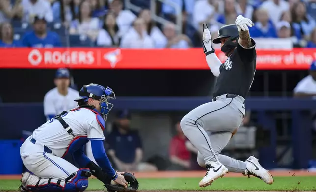 Chicago White Sox's Korey Lee scores ahead of the tag from Toronto Blue Jays catcher Danny Jansen during the second inning of a baseball game Tuesday, May 21, 2024, in Toronto. (Christopher Katsarov/The Canadian Press via AP)