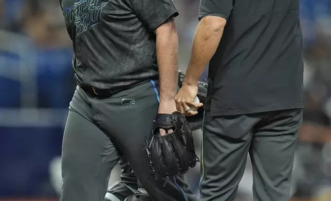 Tampa Bay Rays starting pitcher Aaron Civale, left, gets taken out of the game against the Chicago White Sox by manager Kevin Cash, right, during the fifth inning of a baseball game Wednesday, May 8, 2024, in St. Petersburg, Fla. (AP Photo/Chris O'Meara)