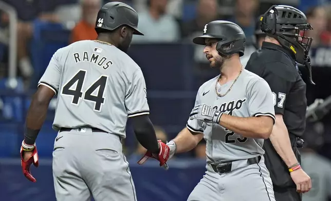 Chicago White Sox's Paul DeJong (29) celebrates with Bryan Ramos (44) after DeJong hit a two-run home run off Tampa Bay Rays starting pitcher Aaron Civale during the fifth inning of a baseball game Wednesday, May 8, 2024, in St. Petersburg, Fla. (AP Photo/Chris O'Meara)
