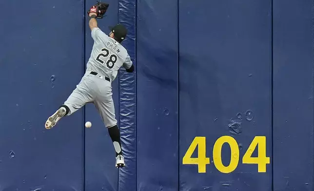 Chicago White Sox center fielder Tommy Pham leaps but can't make the catch on a triple by Tampa Bay Rays' Amed Rosario during the third inning of a baseball game Monday, May 6, 2024, in St. Petersburg, Fla. (AP Photo/Chris O'Meara)
