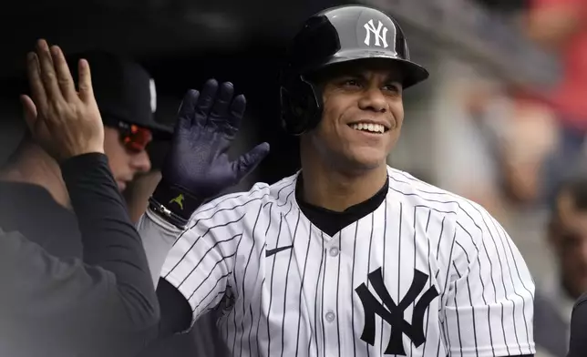 New York Yankees' Juan Soto celebrates with teammates after hitting a home run during the fifth inning of a baseball game against the Chicago White Sox, Saturday, May 18, 2024, in New York. The Yankees won 6-1. (AP Photo/Frank Franklin II)