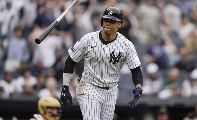 New York Yankees' Juan Soto flips his bat after hitting a home run during the fifth inning of a baseball game against the Chicago White Sox, Saturday, May 18, 2024, in New York. The Yankees won 6-1. (AP Photo/Frank Franklin II)