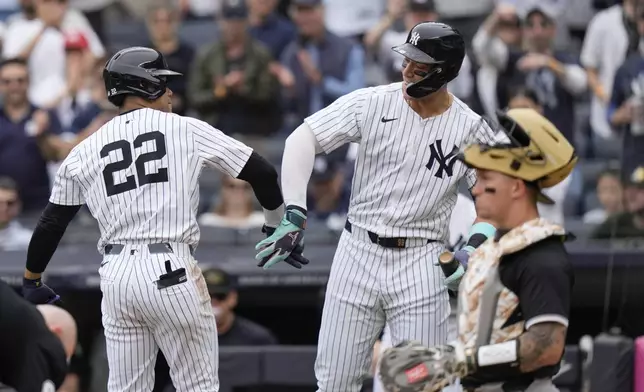 New York Yankees' Juan Soto, left, celebrates with Aaron Judge after hitting a home run during the first inning of a baseball game against the Chicago White Sox, Saturday, May 18, 2024, in New York. (AP Photo/Frank Franklin II)
