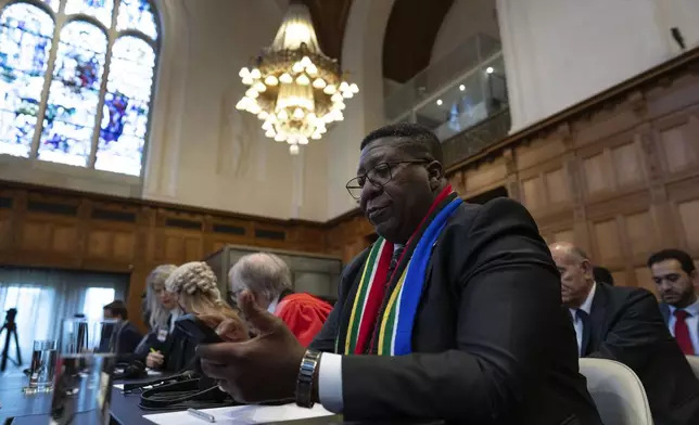Ambassador of the Republic of South Africa to the Netherlands, Vusimuzi Madonsela, wait for judges to enter the International Court of Justice, or World Court, in The Hague, Netherlands, Friday, May 24, 2024, where the top United Nations court was to rule on an urgent plea by South Africa for judges to order Israel to halt its military operations in Gaza and withdraw from the enclave. (AP Photo/Peter Dejong)