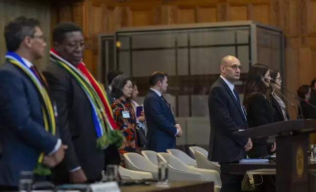 Front row from left, South Africa's agents Cornelius Scholtz, Vusimuzi Madonsela and Israel's agents Gilad Naom, Tamar Kaplan Tourgeman and co-agent Avigail Frisch Ben Avraham wait for the start of hearings at the International Court of Justice, in The Hague, Netherlands, Thursday, May 16, 2024. The U.N.'s top court opened two days of hearings in a case brought by South Africa to see whether Israel needs to take additional measures to alleviate the suffering in war-ravaged Gaza. (AP Photo/Peter Dejong)