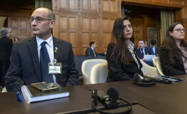 Israel's agents Gilad Naom, left, Tamar Kaplan Tourgeman, center, and co-agent Avigail Frisch Ben Avraham, right, wait for the start of hearings at the International Court of Justice, in The Hague, Netherlands, Thursday, May 16, 2024. The U.N.'s top court opened two days of hearings in a case brought by South Africa to see whether Israel needs to take additional measures to alleviate the suffering in war-ravaged Gaza. (AP Photo/Peter Dejong)