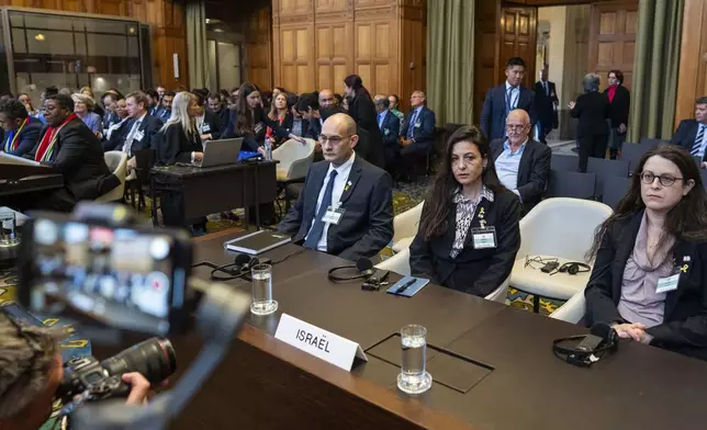 Israel's agent Gilad Naom, front third right, and Tamar Kaplan Tourgeman, front center, wait for the start of hearings at the International Court of Justice, in The Hague, Netherlands, Thursday, May 16, 2024. The U.N.'s top court opened two days of hearings in a case brought by South Africa to see whether Israel needs to take additional measures to alleviate the suffering in war-ravaged Gaza. (AP Photo/Peter Dejong)