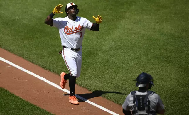 Baltimore Orioles' Jorge Mateo, left, celebrates his home run during the fourth inning of a baseball game as New York Yankees catcher Austin Wells looks on at lower right, Thursday, May 2, 2024, in Baltimore. (AP Photo/Nick Wass)