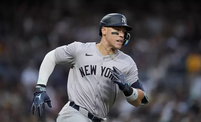 New York Yankees' Aaron Judge runs towards first after hitting a double during the fourth inning of a baseball game against the San Diego Padres, Saturday, May 25, 2024, in San Diego. (AP Photo/Gregory Bull)