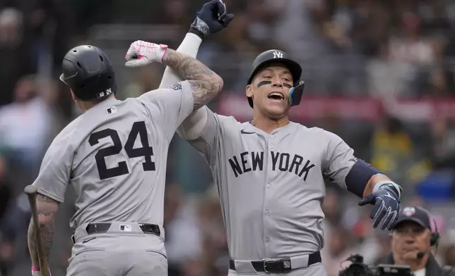 New York Yankees' Aaron Judge, right, celebrates with teammate Alex Verdugo after hitting a two-run home run during the first inning of a baseball game against the San Diego Padres, Saturday, May 25, 2024, in San Diego. (AP Photo/Gregory Bull)