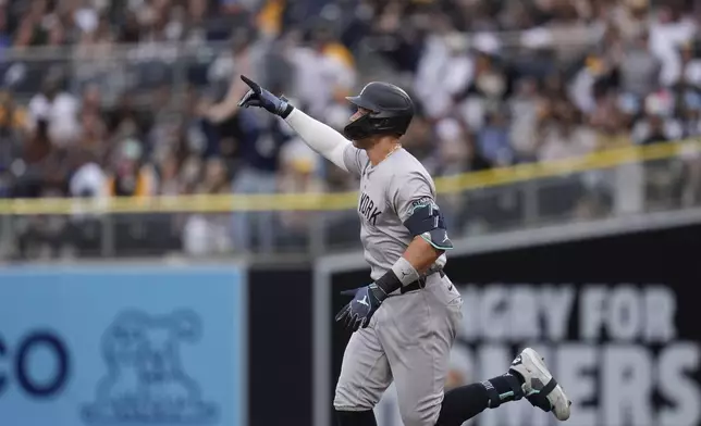 New York Yankees' Aaron Judge celebrates after hitting a two-run home run during the first inning of a baseball game against the San Diego Padres, Saturday, May 25, 2024, in San Diego. (AP Photo/Gregory Bull)