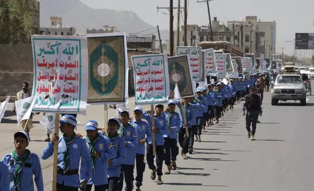Yemeni students carry anti-Israel and anti-U.S. banners during a march organized by Houthis, to show solidarity with Palestinians in the Gaza Strip, in Sanaa, Yemen, Sunday, May 5, 2024. The Arabic reads, "God is great, Death to Israel, Death to America". (AP Photo/Osamah Abdulrahman)