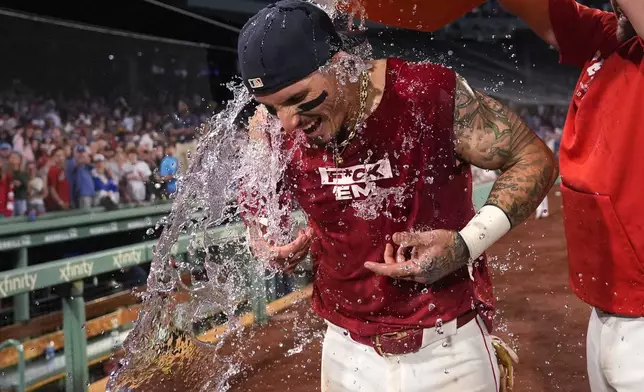 Boston Red Sox's Jarren Duran is doused with water after his walk-off RBI single in the bottom of the ninth inning of a baseball game against the Toronto Blue Jays at Fenway Park, Monday, June 24, 2024, in Boston. (AP Photo/Charles Krupa)