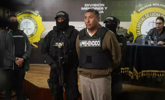 Police hold the detained Juan Arnez Salvador, ex-commander general of the Bolivian Navy, in La Paz, Bolivia, Wednesday, June 26, 2024. An apparent failed coup attempt erupted Wednesday in Bolivia. (AP Photo/Juan Karita)