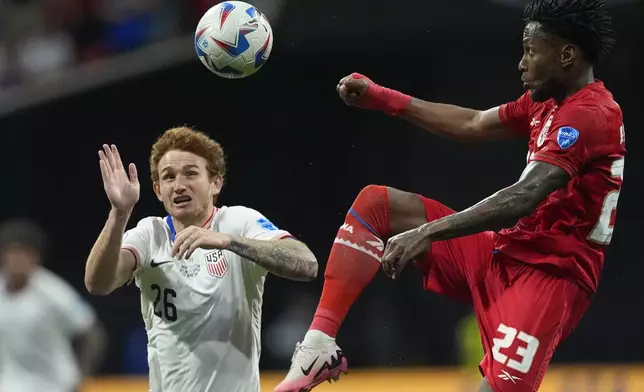 Panama's Michael Murillo, right, jumps for a ball challenged by Josh Sargent of the United States during a Copa America Group C soccer match in Atlanta, Thursday, June 27, 2024. (AP Photo/Mike Stewart)