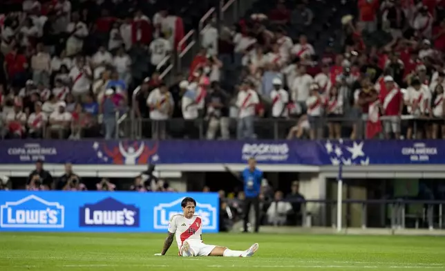 Peru's Gianluca Lapadula sits on the field at the end of a Copa America Group A soccer match against Chile in Arlington, Texas, Friday, June 21, 2024. (AP Photo/Tony Gutierrez)