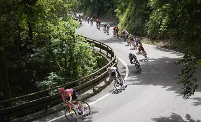 The pack speeds down Col de Valico Tre Faggi during the first stage of the Tour de France cycling race over 206 kilometers (128 miles) with start in Florence and finish in Rimini, Italy, Saturday, June 29, 2024. (AP Photo/Jerome Delay)