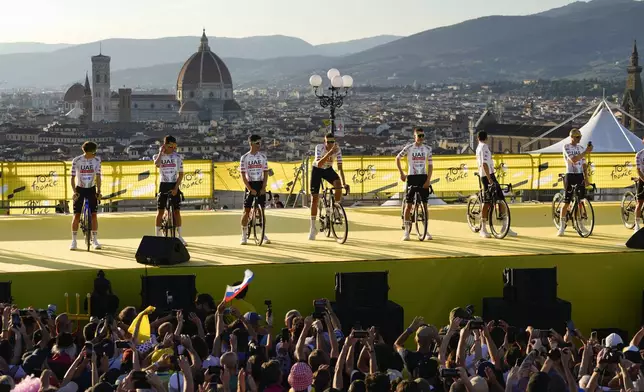 UAE Team Emirates riders with Slovenia's Tadej Pogacar, left, line up during the team presentation in Florence, Italy, Thursday, June 27, 2024, two days before the start of the Tour de France cycling race. (AP Photo/Jerome Delay)