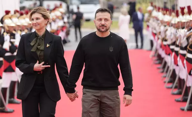 Ukrainian President Volodymyr Zelenskyy and his wife Olena Zelenska, arrive at the international ceremony at Omaha Beach, Thursday, June 6, 2024 in Normandy. Normandy is hosting various events to officially commemorate the 80th anniversary of the D-Day landings that took place on June 6, 1944. (AP Photo/Viginia Mayo)