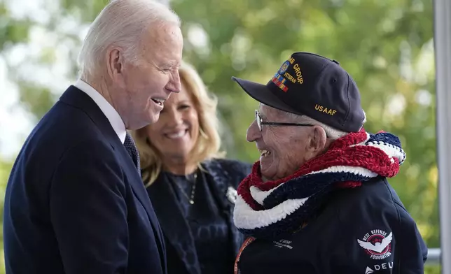 President Joe Biden and first lady Jill Biden, greet a World War II veteran during ceremonies to mark the 80th anniversary of D-Day, Thursday, June 6, 2024, in Normandy. (AP Photo/Evan Vucci)