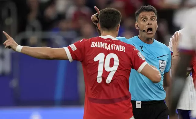 Referee Jesus Gil Manzano of Spain, right, talks to Austria's Christoph Baumgartner during a Group D match between Austria and France at the Euro 2024 soccer tournament in Duesseldorf, Germany, Monday, June 17, 2024. (AP Photo/Martin Meissner)
