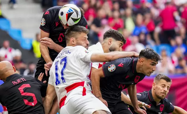 Albania's Berat Djimsiti, top, goes for a header with Croatia's Bruno Petkovic during a Group B match between Croatia and Albania at the Euro 2024 soccer tournament in Hamburg, Germany, Wednesday, June 19, 2024. (AP Photo/Ebrahim Noroozi)