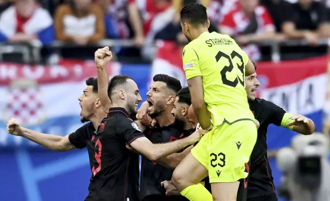 Albania's scorer Klaus Gjasula, third left, and his teammates celebrate their side's second goal during a Group B match between Croatia and Albania at the Euro 2024 soccer tournament in Hamburg, Germany, Wednesday, June 19, 2024. (Sina Schuldt/dpa via AP)