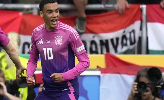 Germany's Jamal Musiala celebrates after scoring his side's opening goal during a Group A match between Germany and Hungary at the Euro 2024 soccer tournament in Stuttgart, Germany, Wednesday, June 19, 2024. (AP Photo/Ariel Schalit)