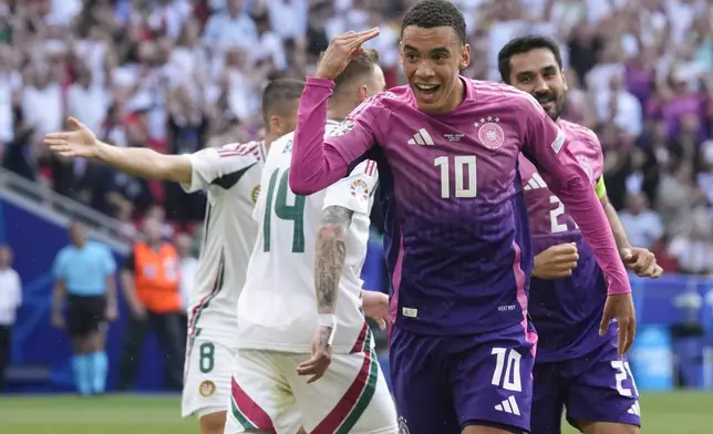 Germany's Jamal Musiala (10) celebrates after scoring during a Group A match between Germany and Hungary at the Euro 2024 soccer tournament in Stuttgart, Germany, Wednesday, June 19, 2024. (AP Photo/Darko Vojinovic)