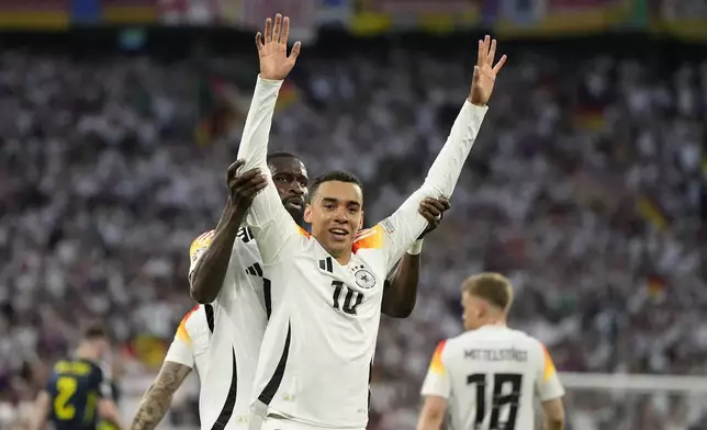 Germany's Jamal Musiala celebrates after scoring his side's second goal during a Group A match between Germany and Scotland at the Euro 2024 soccer tournament in Munich, Germany, Friday, June 14, 2024. (AP Photo/Matthias Schrader)