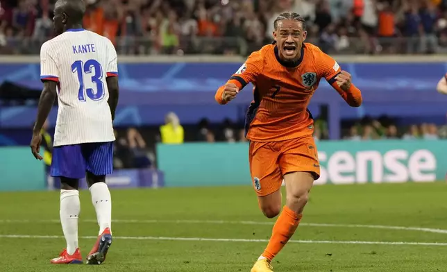 Xavi Simons of the Netherlands, right, celebrates after scoring a goal that was then disallowed for offside during the Group D match between the Netherlands and France at the Euro 2024 soccer tournament in Leipzig, Germany, Friday, June 21, 2024. (AP Photo/Hassan Ammar)