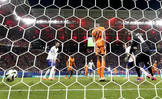 Xavi Simons of the Netherlands, right, scores a later disallowed goal during a Group D match between the Netherlands and France at the Euro 2024 soccer tournament in Leipzig, Germany, Friday, Nov. 21, 2024. (AP Photo/Hassan Ammar)