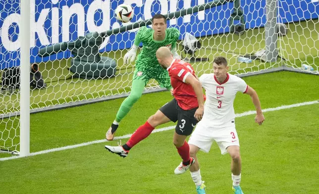 Austria's Gernot Trauner, left, scores the opening goal during a Group D match between Poland and Austria at the Euro 2024 soccer tournament in Berlin, Germany, Friday, June 21, 2024. (AP Photo/Petr Josek)