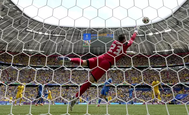 Romania's Nicolae Stanciu, fourth left, scores the opening goal during a Group E match between Romania and Ukraine at the Euro 2024 soccer tournament in Munich, Germany, Monday, June 17, 2024. (AP Photo/Matthias Schrader)