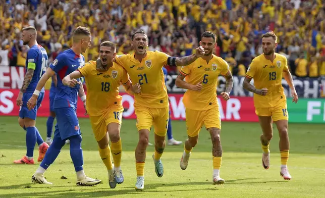 Romania's Razvan Marin (18) celebrates after scoring his side's first goal against Slovakia during a Group E match at the Euro 2024 soccer tournament in Frankfurt, Germany, Wednesday, June 26, 2024. (AP Photo/Themba Hadebe)