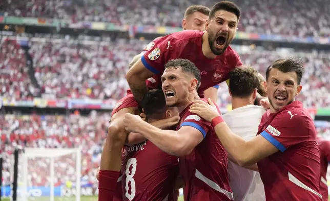 Serbia's players celebrate their sides first goal against Slovenia during a Group C match between Slovenia and Serbia at the Euro 2024 soccer tournament in Munich, Germany, Thursday, June 20, 2024. (AP Photo/Matthias Schrader)