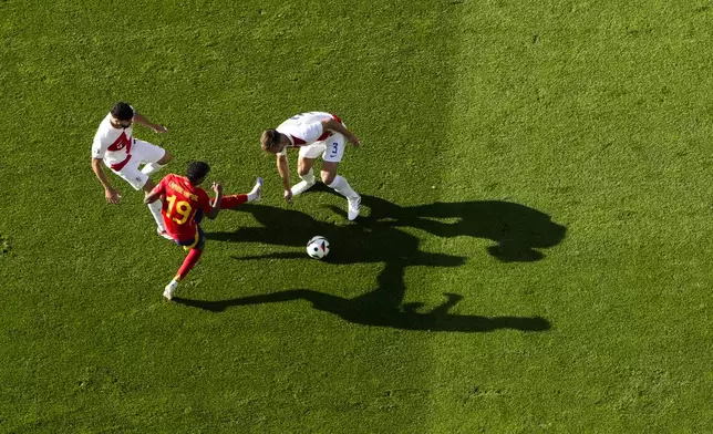 Spain's Lamine Yamal, center, challenges for the ball with Croatia's Josko Gvardiol, left, and Croatia's Marin Pongracic, right, during a Group B match between Spain and Croatia at the Euro 2024 soccer tournament in Berlin, Germany, Saturday, June 15, 2024. Lamine Yamal was set to become the youngest player ever to play at a European Championship on Saturday when he was named in Spain's starting lineup for its Group B-opening game against Croatia. (AP Photo/Petr Josek)