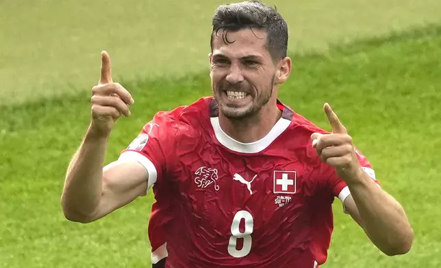 Switzerland's Remo Freuler celebrates after scoring his side's opening goal during a round of sixteen match between Switzerland and Italy at the Euro 2024 soccer tournament in Berlin, Germany, Saturday, June 29, 2024. (AP Photo/Markus Schreiber)