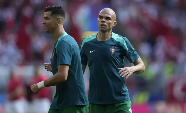 Portugal's Cristiano Ronaldo, left, and Portugal's Pepe warm up prior of a Group F match between Turkey and Portugal at the Euro 2024 soccer tournament in Dortmund, Germany, Saturday, June 22, 2024. (AP Photo/Themba Hadebe)