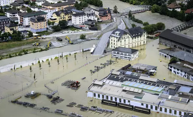 A view of the Rhone river, at right, and the Navizence river, following the storms that caused major flooding, in Chippis, Switzerland, Sunday, June 30, 2024. The Rhone river burst its banks in several areas of Valais canton, flooding a highway and a railway line. (Jean-Christophe Bott/Keystone via AP)