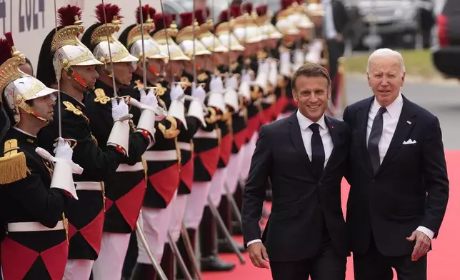 United States President Joe Biden, right, and French President Emmanuel Macron arrive at the international ceremony at Omaha Beach, Thursday, June 6, 2024, in Normandy, France. Normandy is hosting various events to officially commemorate the 80th anniversary of the D-Day landings that took place on June 6, 1944. (AP Photo/Virginia Mayo, Pool)