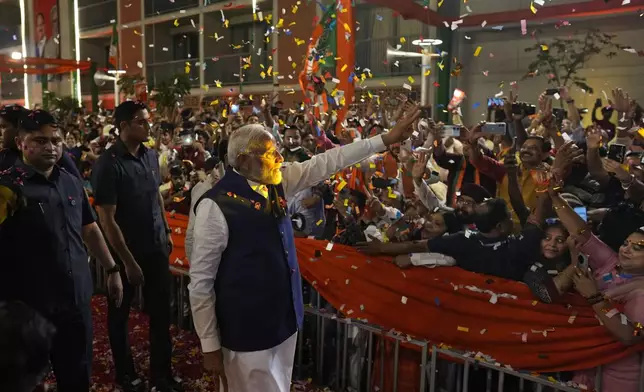 Prime Minister Narendra Modi is greeted by supporters as he arrives at Bharatiya Janata Party (BJP) headquarters in New Delhi, India, Tuesday, June 4, 2024. (AP Photo/Manish Swarup)