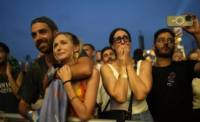 A woman weeps at the Nova Healing Concert in Tel Aviv, Israel, on Thursday, June 27, 2024. This was the first Tribe of Nova mass gathering since the Oct. 7, 2023 cross-border attack by Hamas that left hundreds at the Nova music festival dead or kidnapped to Gaza. (AP Photo/Ohad Zwigenberg)
