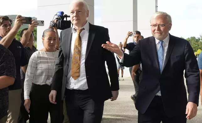 WikiLeaks founder Julian Assange, center, arrives at the United States courthouse where he is expected enter a plea deal in Saipan, Mariana Islands, Wednesday, June 26, 2024. (AP Photo/Eugene Hoshiko)